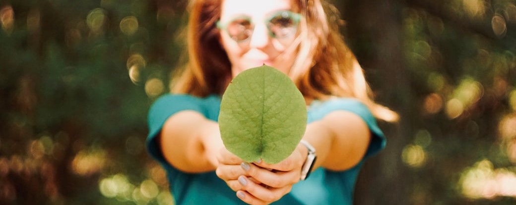 Woman holding leaf